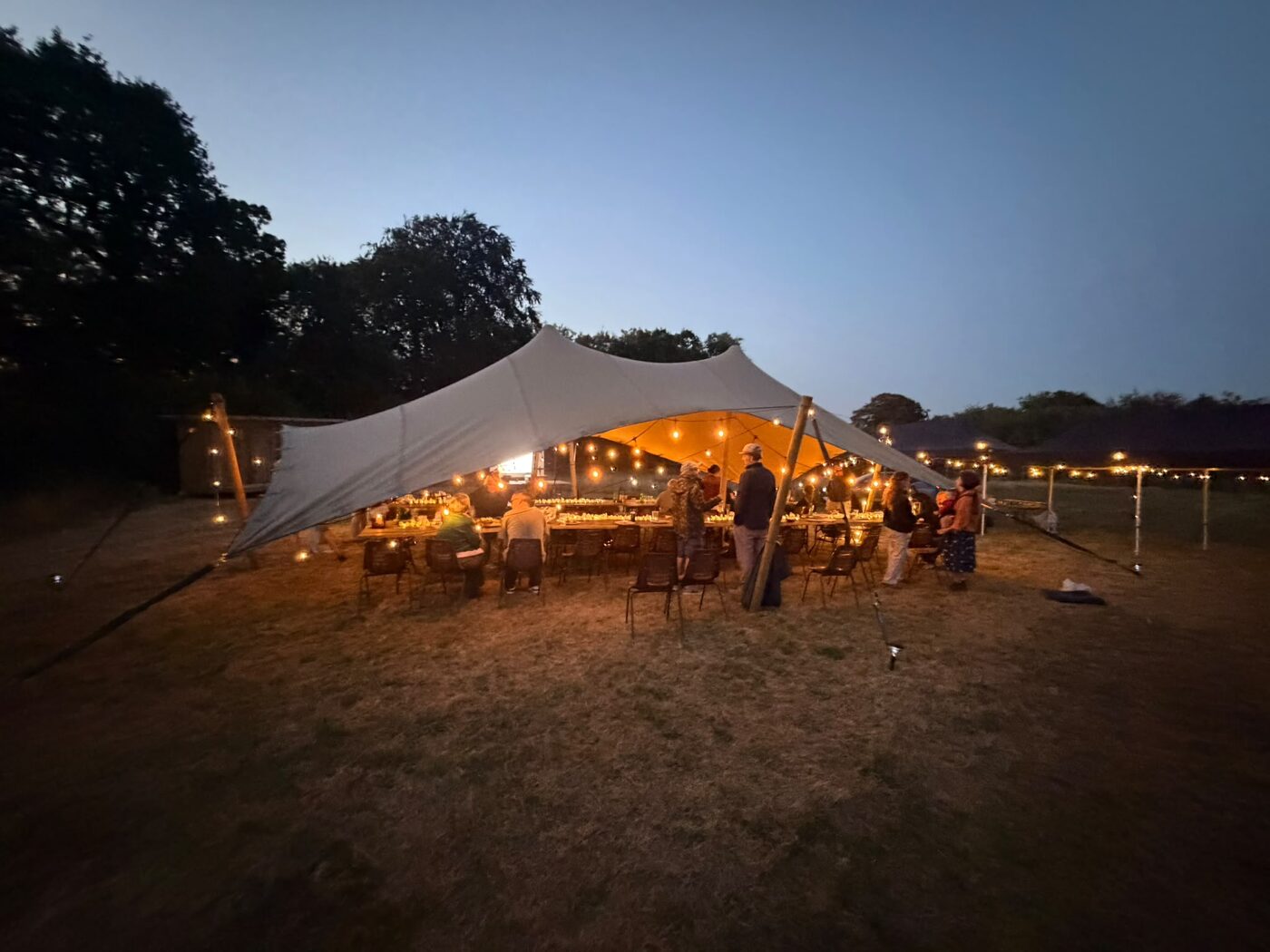 Members gathered beneath the stretch tent at Celtic Roots Farm & Gardens